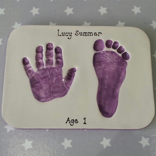 Rectangle Clay Imprint with hand and footprint in purple.  Unframed.