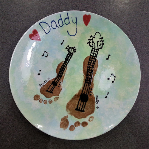 Large Coupe Plate with two brown footprints turned into guitars, as a gift for Daddy.