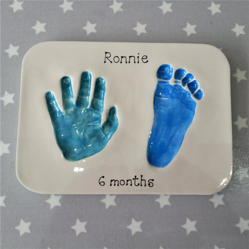 Rectangle Clay Imprint with hand and footprint.  Hand print in teal and footprint in blue.  Unframed. 