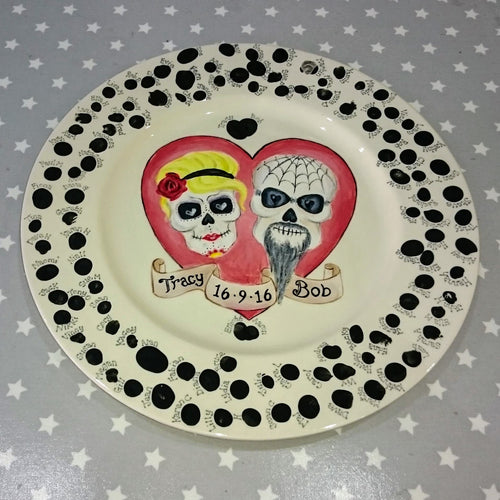 A wedding plate commission painted after the wedding where all guests added their prints.