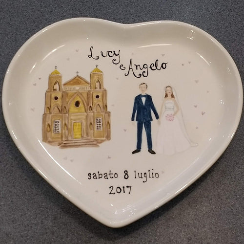 A wedding plate of the bride and groom and a recreation of the castle they were married in.
