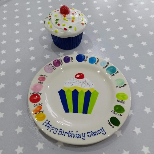 A birthday party keepsake plate from a party at Create It, with painted fingerprints of the guests and a cupcake painted in the centre.  With a cupcake trinket box, painted with bright colours.