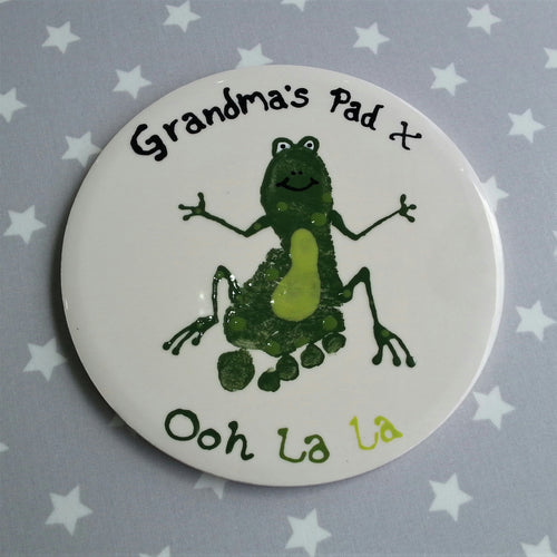 Large round tile with green footprint made into a frog, as a gift for Grandma.