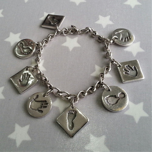 Love Prints chunky bracelet with 8 medium charms with the whole family's hand and footprints.