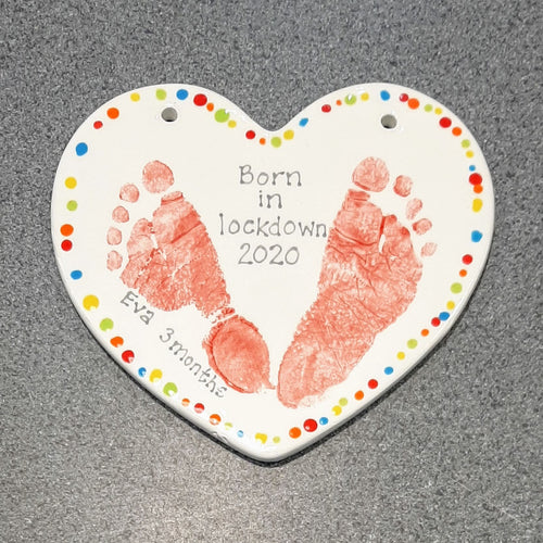 Medium Heart Plaque with two red footprints and rainbow dots around the edge.