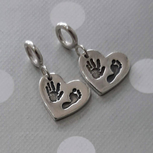 Love Prints heart charms with hand and foot prints with spacer attachments to be put on snake style bracelet systems.