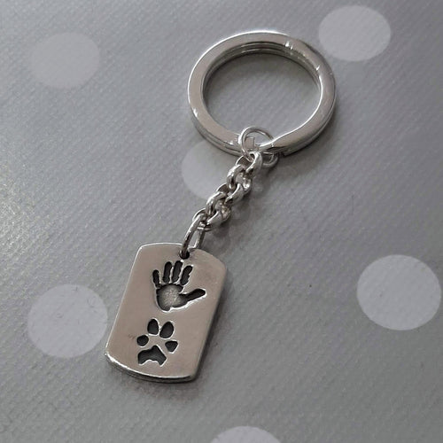 Love Prints dog tag shaped charm with hand print and paw print on sterling silver key chain and keyring.