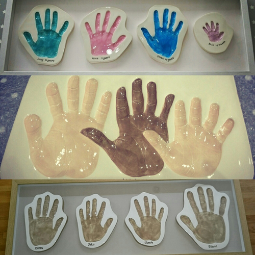 A selection of hand print Clay Imprints.  Three hand prints in browns and beiges on one piece of clay and cut out hand print Clay Imprints.