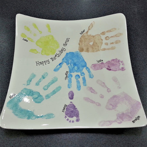 Family hand and footprints on a large square platter, made as a gift for Grandma.