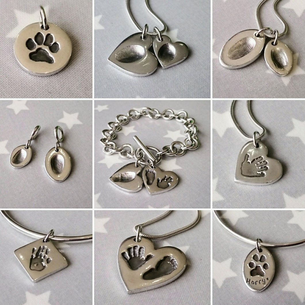 Some of our Love Prints silver imprint charms with fingerprints, hand and footprints and pawprints.