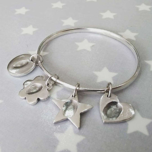 Love Prints Silver Fingerprint Bangle with circle, flower, star and heart charms.