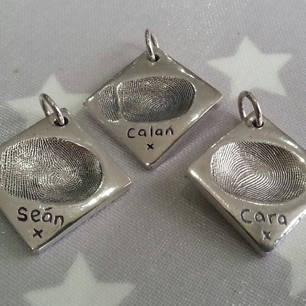 Love Prints diamond shaped silver fingerprint charms with children's names on the front. 