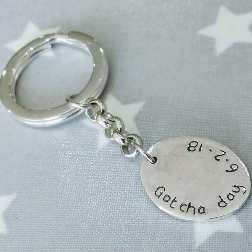 Love Prints reverse side of large oval charm with writing and date on sterling silver key chain and keyring.