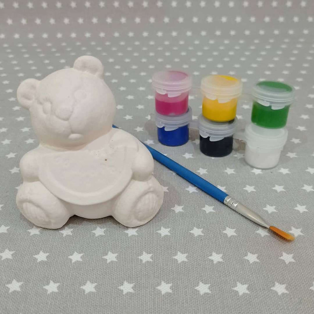 Ready to paint pottery, Teddy holding Watermelon with acrylic paints and brush